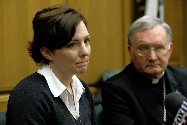 Thomas Hodgman sexual abuse victim Joelle Casteix speaks out at a press conference as Bishop Todd Brown from the Orange Diocese looks on.