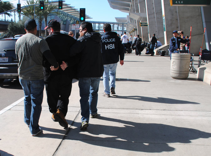 Joel A.Wright, second from left, was arrested at the San Diego airport on Friday. Credit U.S. Immigration and Customs Enforcement, via Associated Press